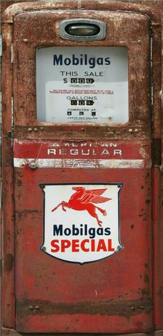 an old red gas pump with a sign on it's side that says mobligas