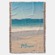 a blanket with the name monica written on it in blue and green watercolors