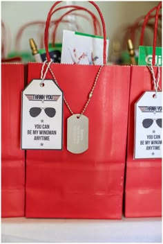 red shopping bags with tags attached to them