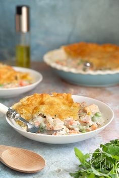 two bowls filled with chicken pot pie on top of a table