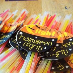 several halloween candles are arranged in rows on a table with tags attached to the sticks