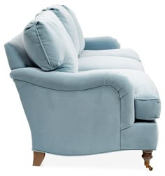 a light blue couch sitting on top of a white floor