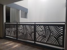 a balcony with an iron fence and sliding glass doors