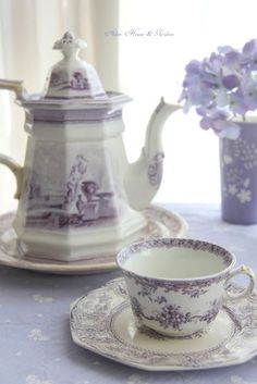 a tea pot and saucer sitting on a table