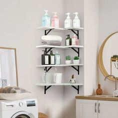 a washer and dryer in a room with shelves on the wall above them