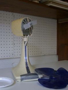 an old style fan sitting on top of a table