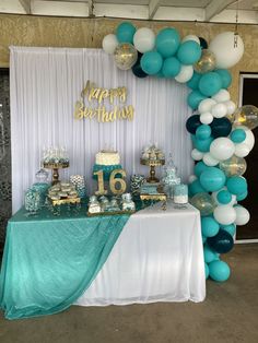 a table topped with balloons and cake