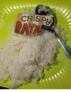 a green plate topped with white rice and a tag that says crispy pata