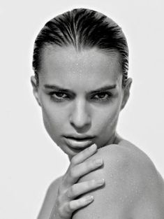 a black and white photo of a woman with her hands on her chest