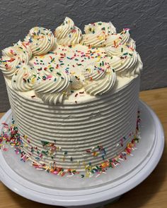 a cake with white frosting and sprinkles