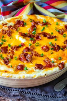 a cheesy dish with bacon and green onions