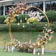 a wedding arch decorated with flowers and candles