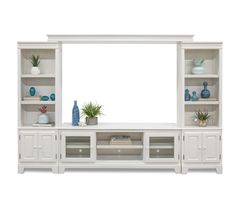 a large white entertainment center with shelves and vases on the top one shelf is empty