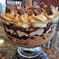 a glass bowl filled with chocolate and marshmallows on top of a table