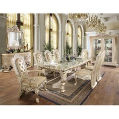 a fancy dining room with chandelier and table in it's centerpiece