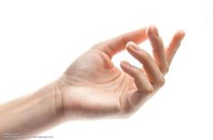 a person's hand holding something in the air with their thumb extended to the side