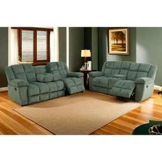 two reclining sofas sitting on top of a wooden floor in a living room