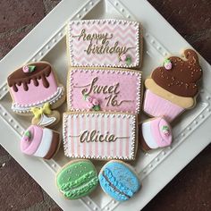 decorated cookies on a white plate with words