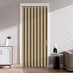 a living room with a white couch and brown vertical blinds on the sliding glass door