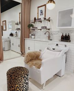 a bath room with a tub a chair and a mirror on the wall in it