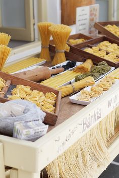 various types of pasta on display at an outdoor market