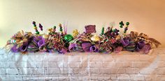 the table is covered with purple and green ribbons, beads, and other decorative items