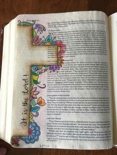 an open bible with flowers on it