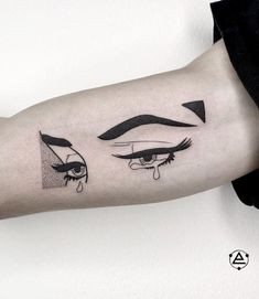 a woman's arm with an eye tattoo on it