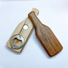 a small wooden knife with a metal blade on it's side next to a wood case