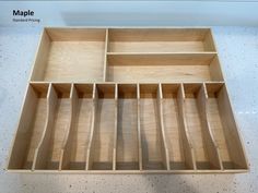 a wooden tray with compartments on top of it in a store or office space for storing items