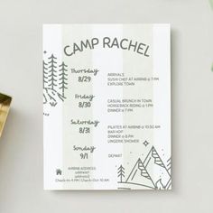 a camp raf card sitting on top of a table next to a cup and plant