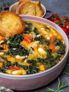 a bowl filled with soup next to some bread