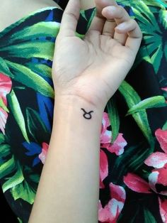 a person with a small tattoo on their wrist