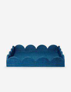 a blue couch sitting on top of a white floor