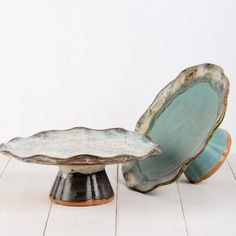 two pieces of pottery sitting on top of each other