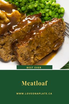 meatloaf with gravy, peas and mashed potatoes on a plate