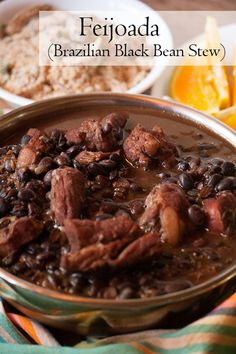 a bowl filled with beans and meat on top of a table