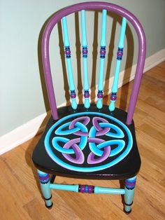 a purple and blue chair sitting on top of a hard wood floor