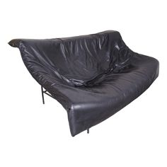 a black leather futon chair with metal legs