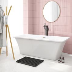 a white bath tub sitting in a bathroom next to a mirror