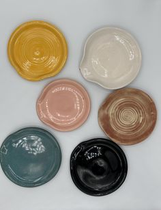 four different colored plates sitting next to each other