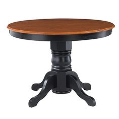 a wooden table with black legs and an oval top