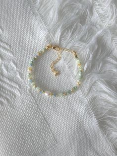 FOR OTHER DAINTY BEADED BRACELETS: https://www.etsy.com/ca/shop/ArtiChouXCanada?ref=seller-platform-mcnav%C2%A7ion_id&section_id=46088511 Bracelet Length: 13-18cm (5.1-7 inches) with a 14k gold filled or sterling silver extender. This bracelet features an assortment of pastel colors: green, yellow, blue, cream, white, and 18k gold filled or sterling silver seed beads. It also contains a freshwater pearl.  Thread may be visible since it is a handmade product   SIZING  Wrap a soft measuring tape s Cheap Green Bracelets With Tiny Beads, Green And Blue Seed Bead Bracelet, Pretty Seed Bead Bracelets, Pink Seed Bead Bracelet Ideas, 2mm Seed Bead Bracelet, Green Pearl Bracelet, Bracelet From Beads, Green Seed Bead Bracelets, Pastel Beaded Bracelets