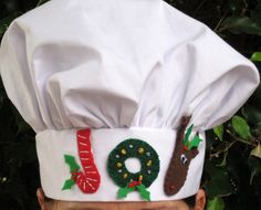 a man wearing a chef's hat with christmas decorations on the front and sides