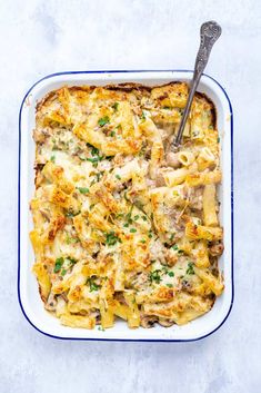 a casserole dish with chicken, cheese and parsley