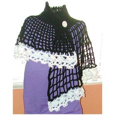 a black and white crochet shawl on display