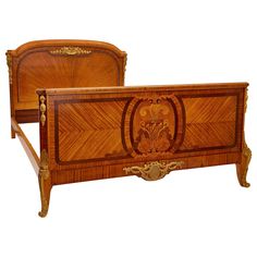 an antique wooden bed with ornate carvings on the headboard