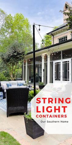 an outdoor patio with chairs, table and string lights on the front porch in front of a house