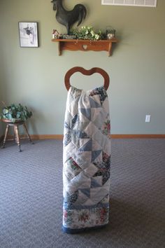 an ironing board cover sitting on top of a wooden chair in a living room