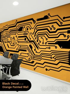 an office with a large computer circuit board on the wall